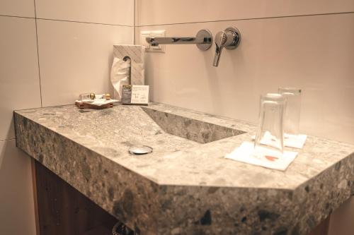 a bathroom counter with a sink and a mirror at Hotel Schartner in Altenmarkt im Pongau