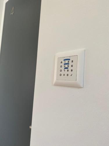 a white lightswitch on a white wall at B&B Cà Nosa in Gordevio