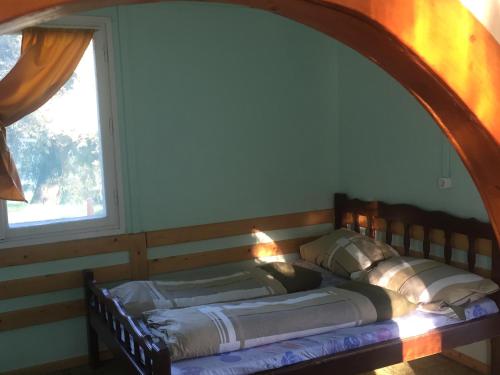 un letto in una camera accanto a una finestra di Bungalow Park a Szentendre