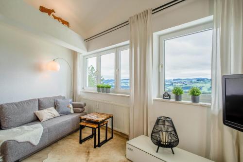 a living room with a couch and a window at Heimelig im Allgäu in Lindenberg im Allgäu