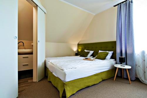 Postel nebo postele na pokoji v ubytování Zacisze Zielone Ogrody