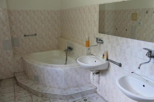 a bathroom with a bath tub and a sink at Chata pod lesom Nová Baňa in Nová Baňa