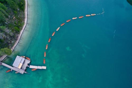 an overhead view of a pier with boats in the water at Hotel Edelweiss in Braies