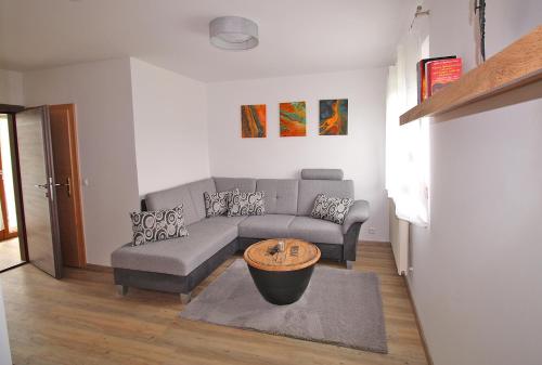 a living room with a couch and a table at Ferienwohnung "Haus Falle" in Schiefling am See