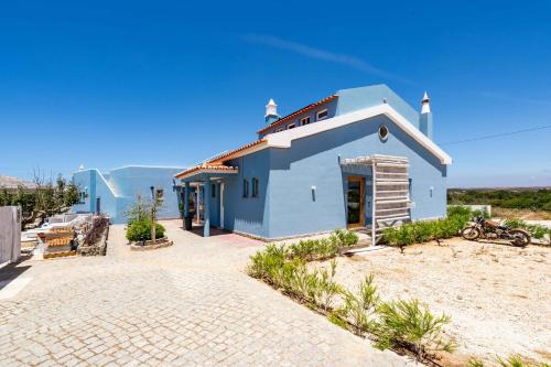 a small blue house on a beach at Wavesensations - Sagres Surf House in Sagres