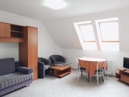 a living room with a table and a couch at St.Flórián Apartman in Keszthely