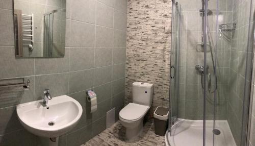 a bathroom with a sink and a toilet and a shower at Авиатик in Zhytomyr