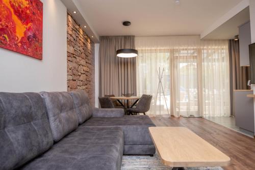 a living room with a couch and a table at Vila Vitalija in Palanga
