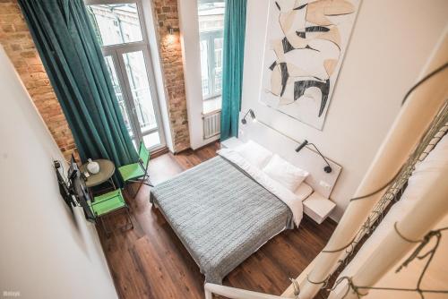 a small room with a bed and a window at Kyiv Art Apartments near Golden Gate in Kyiv