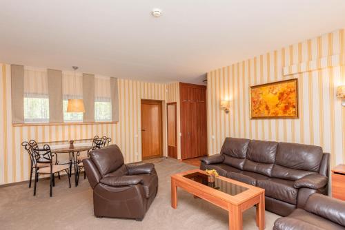 a living room with a couch and a table at Vila Vitalija in Palanga