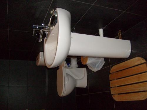 a white toilet in a bathroom with a sink at Seaside Apartment in Carbis Bay