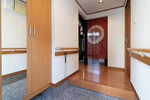 a hallway with a door leading into a room at Casaya TABI-NE in Kanazawa