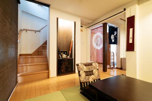 a dining room with a table and a chair at Casaya TABI-NE in Kanazawa