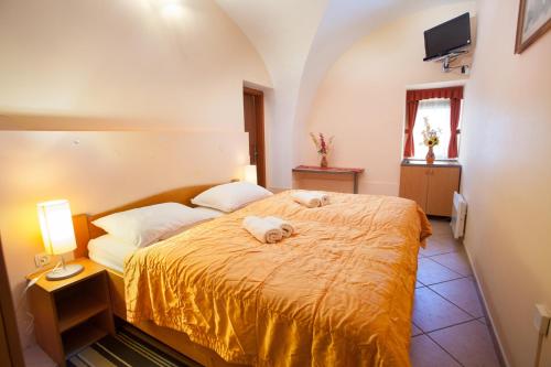 a bedroom with a bed with two dogs laying on it at Apartma na Starem Placu in Idrija