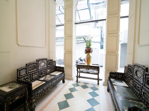 two black benches in a room with a table at The Ecotel Bangkok in Bangkok