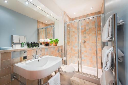 a bathroom with a sink and a shower at Highland Apartments by Mansley in Inverness