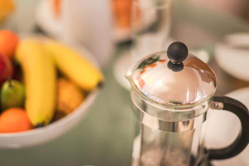 a close up of a juicer with a bowl of fruit at Highland Apartments by Mansley in Inverness