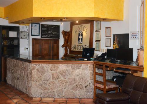 a bar in a restaurant with a counter top at Hotel Las Fuentes in Los Mochis