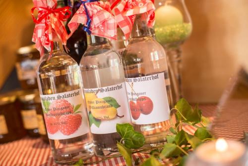 two bottles of wine with strawberries on them on a table at Salaterhof Embach in Lend