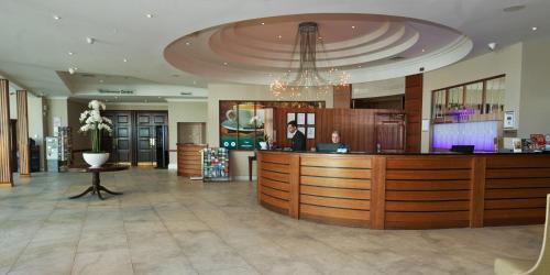 a lobby with a reception desk in a building at Green Isle Hotel, Dublin in Clondalkin 