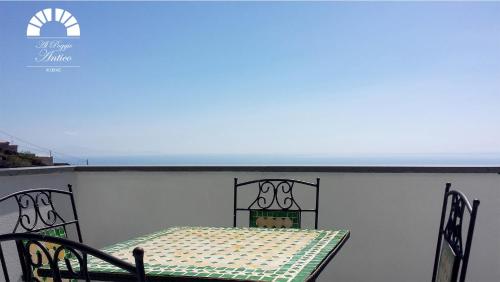 a table and chairs sitting on top of a wall at Al Poggio Antico in Amalfi