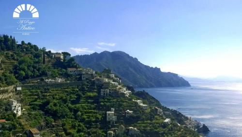 a town on a hill next to the ocean at Al Poggio Antico in Amalfi