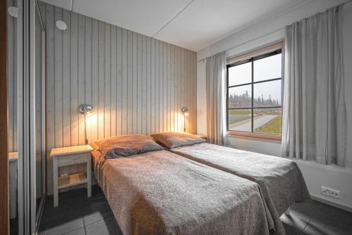 a bedroom with a large bed and a window at Ski-Inn RukaTonttu in Ruka
