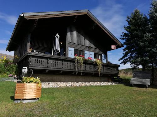 a small house with a porch and a deck at Ferienhaus Ulli in Gansbach