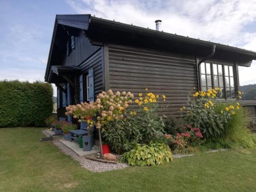 a house with a bunch of flowers in front of it at Ferienhaus Ulli in Gansbach