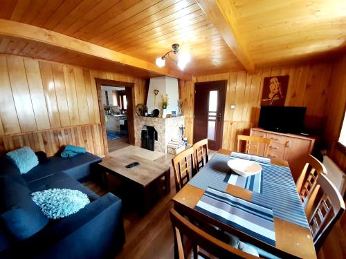 a living room with a blue couch and a table at Andrea- neakceptujeme mladé partie in Terchová