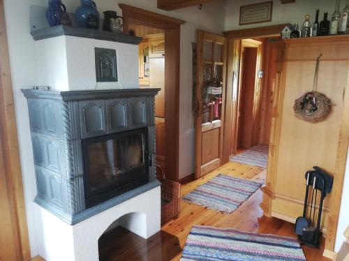 a living room with a fireplace in a house at Ferienhaus Ulli in Gansbach