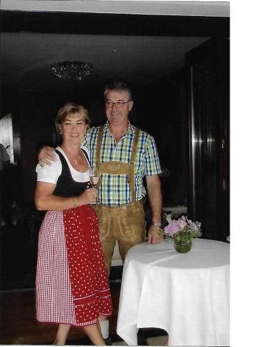 a man and a woman standing next to a table at Ferienhaus Ulli in Gansbach