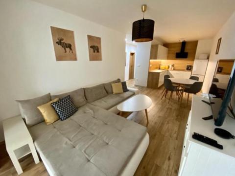 a living room with a couch and a table at Dream apartman in Bojnice