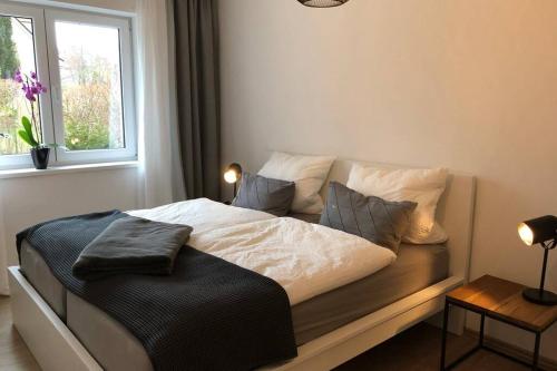 a bedroom with a bed with pillows and a window at Dock 2 apartment in Berlin