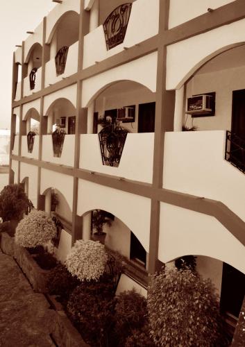 a building with balconies and plants on the side of it at Hotel Las Fuentes in Los Mochis