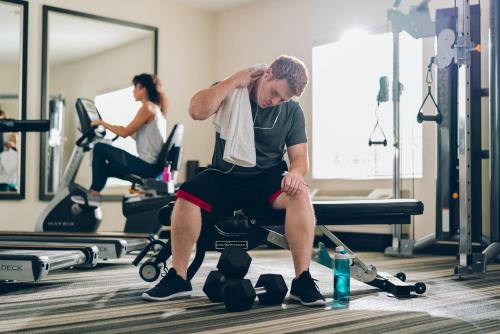 a man sitting on a bench in a gym at Candlewood Suites Boise - Towne Square by IHG in Boise