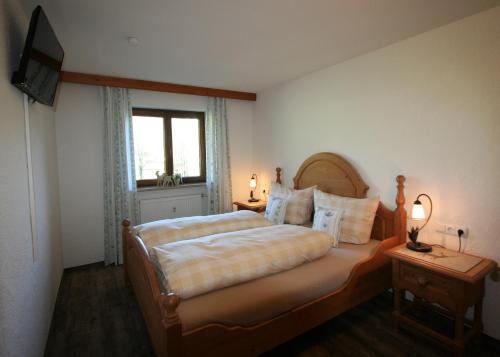 a bedroom with a large bed and a window at Alpenflair Ferienwohnungen Whg 205 in Oberstdorf