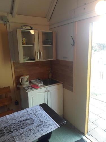 a small kitchen with a sink and a counter at Penzion a Chatový Camp Havraníky u NP Podyjí in Havraníky
