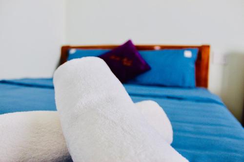 a pair of white socks sitting on a bed at Minh Minh Homestay in Con Dao