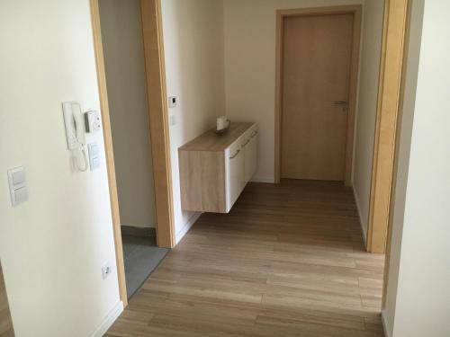 a hallway with a dresser in a room with a door at Aqua Apartman Superior in Velence