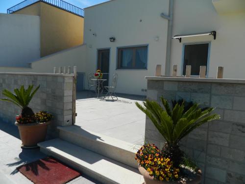 a patio with two potted plants and a building at A Casa di Anna - Locazione Turistica - in Matera