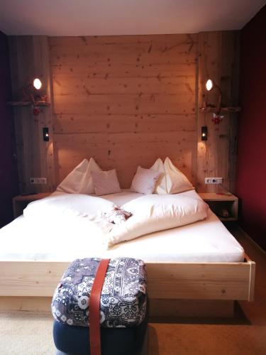 a bedroom with two beds with white sheets at Hotel Ehrwalderhof in Ehrwald