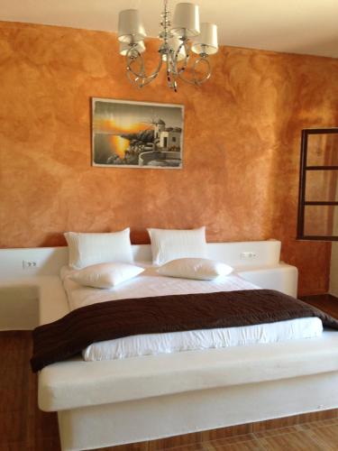 a hotel room with two beds and two lamps at Romantic Spa Resort in Fira
