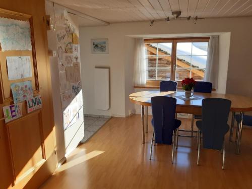 a kitchen and dining room with a table and chairs at Ferienhaus Turba in Bivio