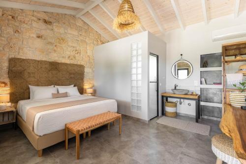 a bedroom with a king sized bed and a table at "Four Olives" Luxury Rooms, Afitos #FeelsLikeHome in Afitos