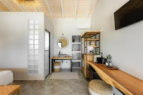 a home office with a desk and a tv at "Four Olives" Luxury Rooms, Afitos #FeelsLikeHome in Afitos