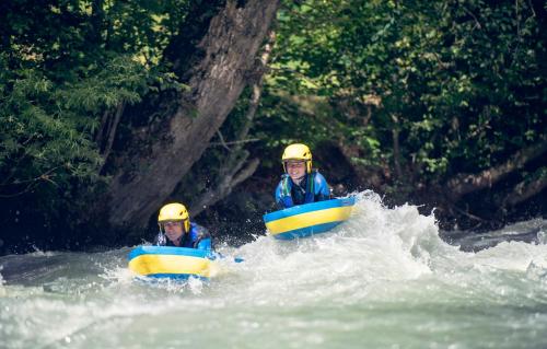 two people are in rafts in a river at Club Alpina - Champagny-en-Vanoise in Champagny-en-Vanoise