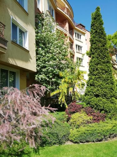 a garden in front of a building at Aparthouse Borovo near Bulgaria Mall, free street parking in Sofia