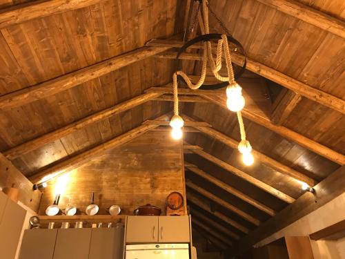 a kitchen with lights hanging from a wooden ceiling at The House in the Cobbled Road in Karpenision