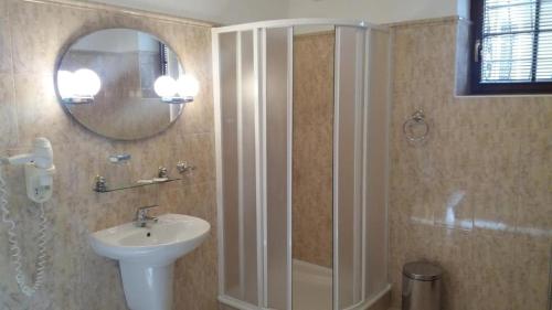 a bathroom with a shower and a sink and a mirror at Hotel Zámeček Pod Hradem Starý Jičín 111 in Starý Jičín